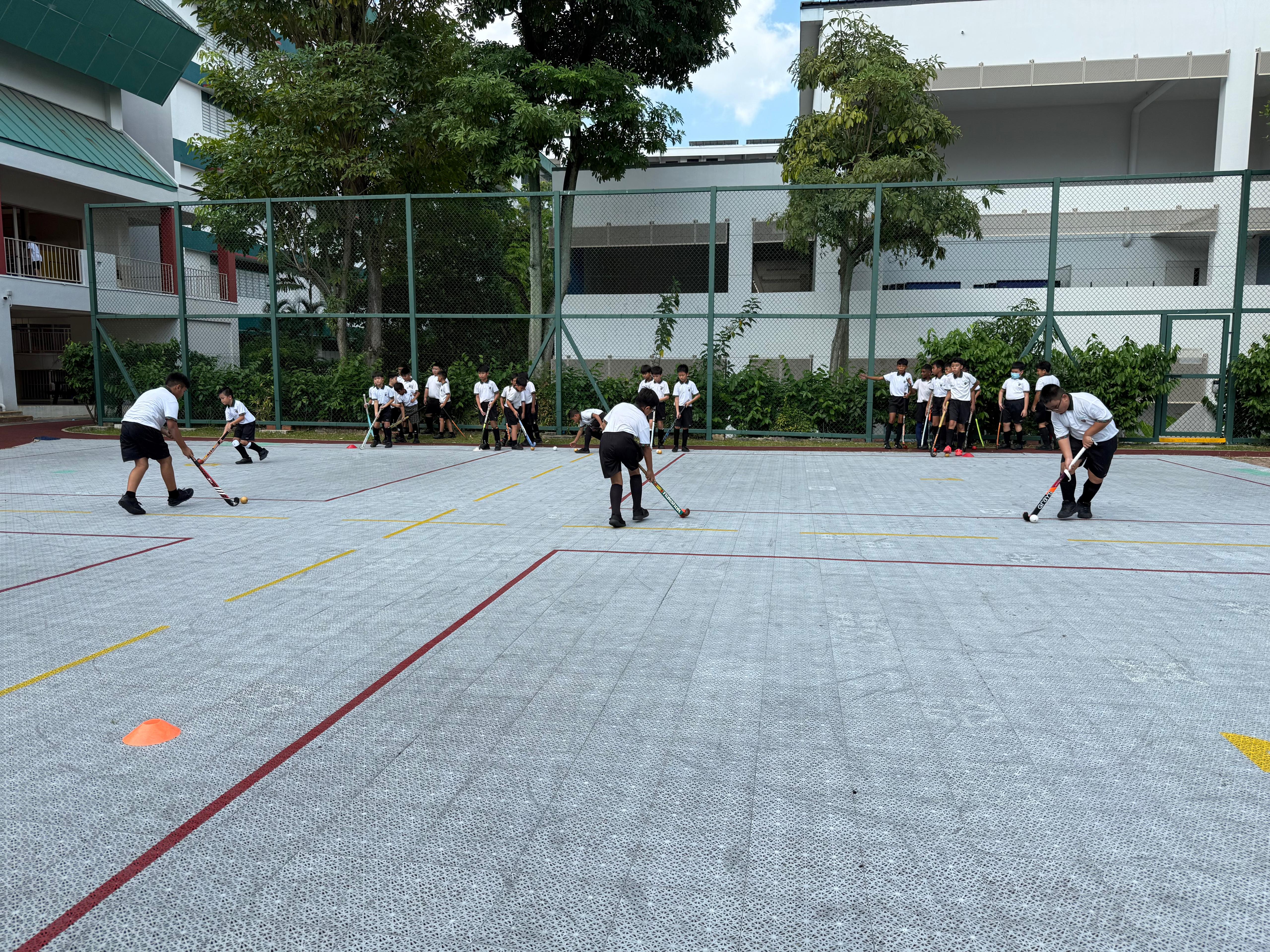 The P3 to P5 Hockey Boys practising their dribbling and passing skills.