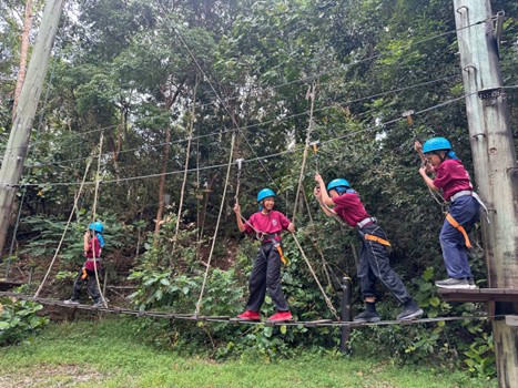 Students having fun and overcoming their fear of heights at the tower circuit