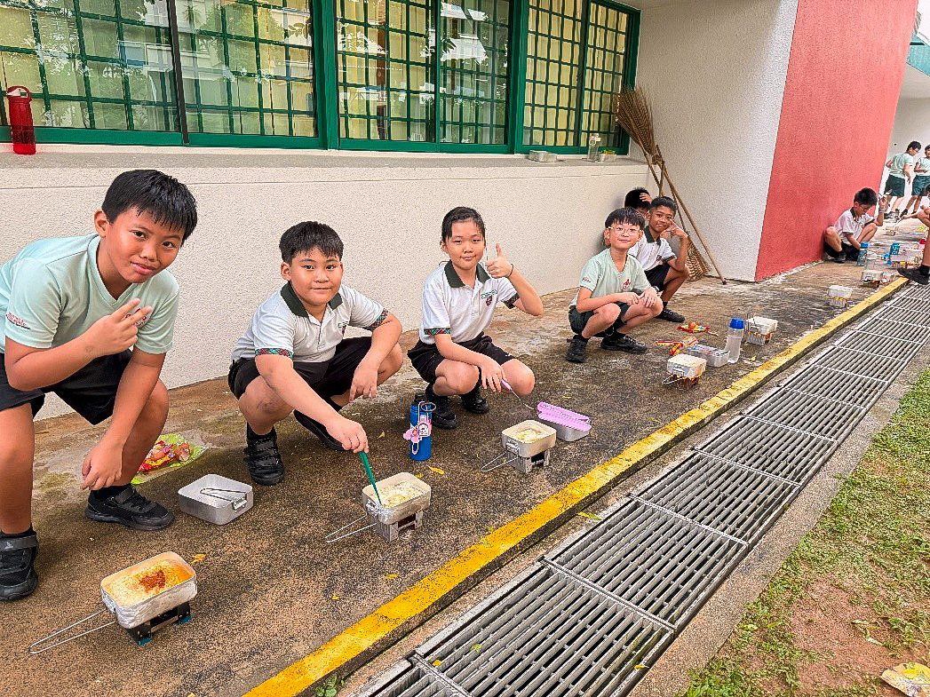 Our Cub Scouts learning to cook their noodles and enjoying their fruits of their labour.